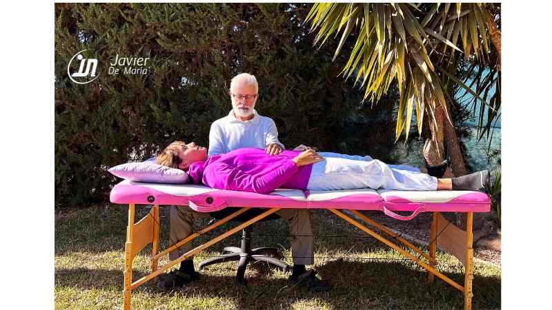 Un terapeuta realiza sesión de terapia craneosacral